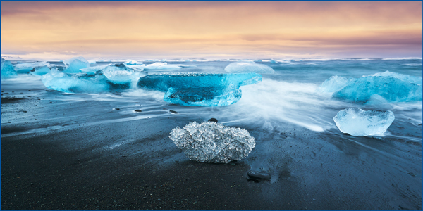 <span>Geographic Treasure:</span> Icebergs wash onto Diamond Beach from the Jökulsárlón Glacier Lagoon, creating a dazzling contrast with the volcanic black sand.